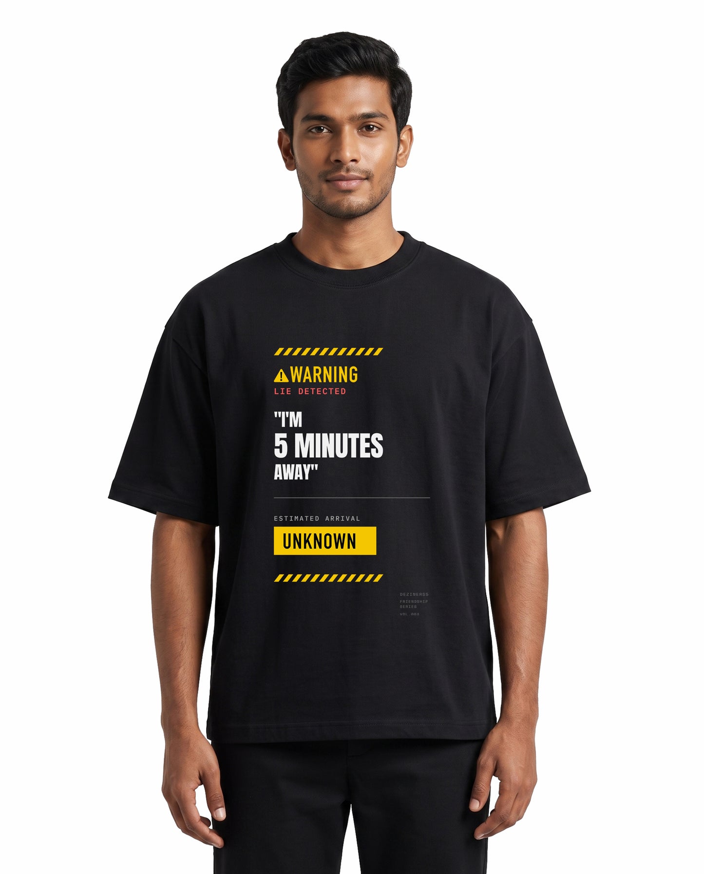 Front view of male model wearing 5 MINS AWAY unisex oversized graphic t-shirt in black in a studio setting.