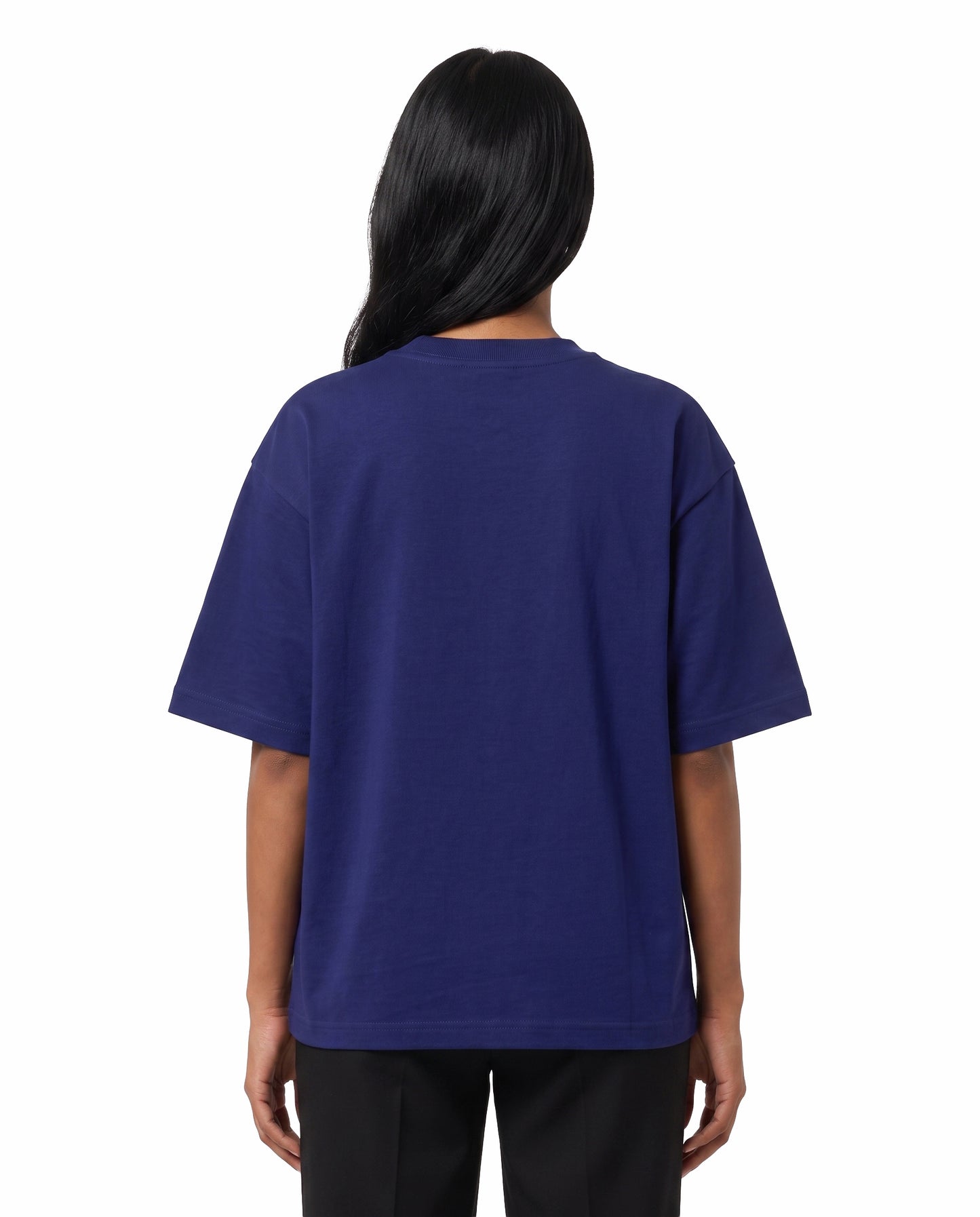 Back view of female model wearing 5 MINS AWAY unisex oversized graphic t-shirt in royal blue in a studio setting.