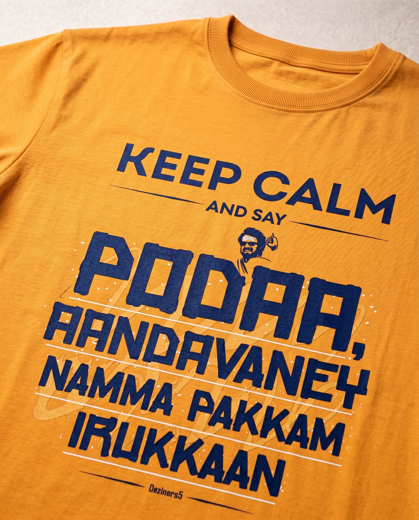 Close-up print detail of AANDAVANEY NAMMA PAKKAM motivational Tamil quote artwork on a golden yellow regular fit t-shirt.