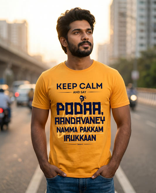 Young South Indian man wearing AANDAVANEY NAMMA PAKKAM golden yellow regular fit t-shirt with motivational Tamil quote artwork in a Chennai lifestyle setting.