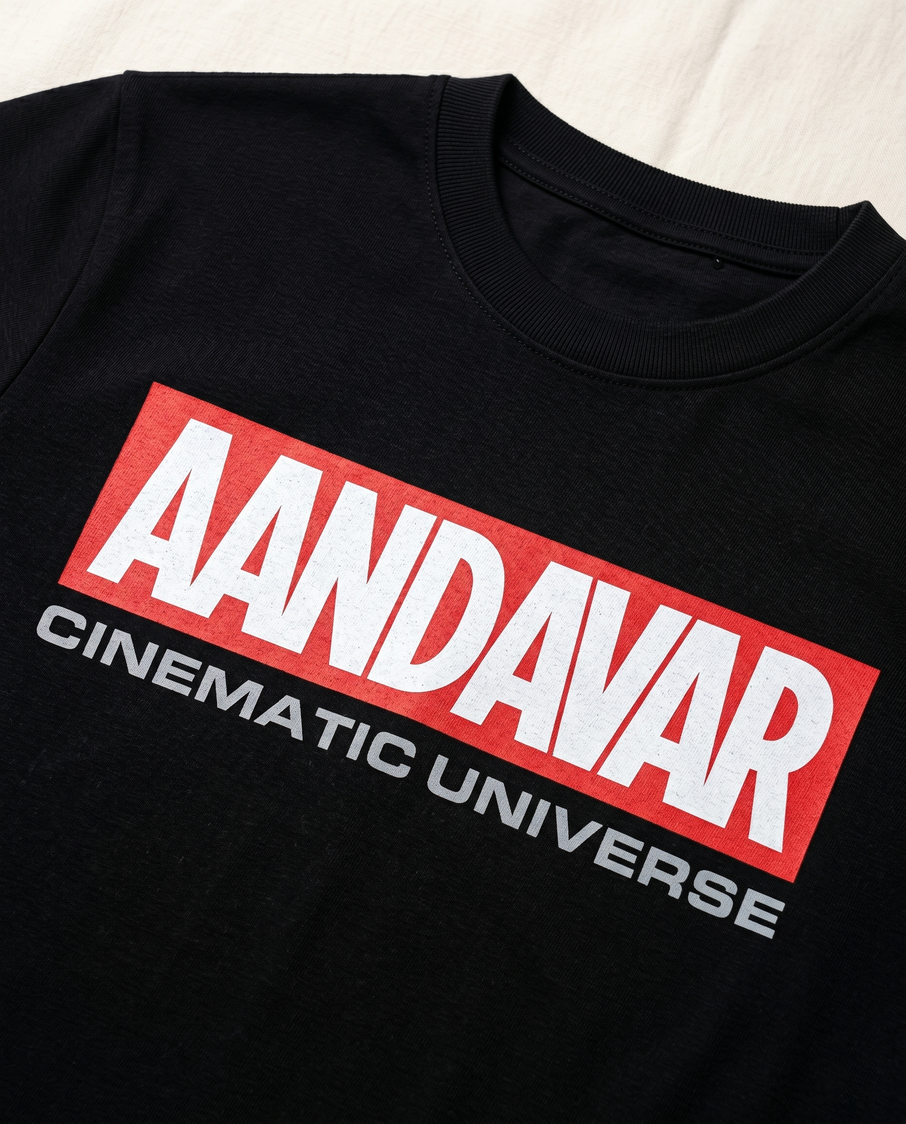 Detailed close-up of the AANDAVAR CINEMATIC UNIVERSE front graphic print on a men's regular-fit t-shirt in black.