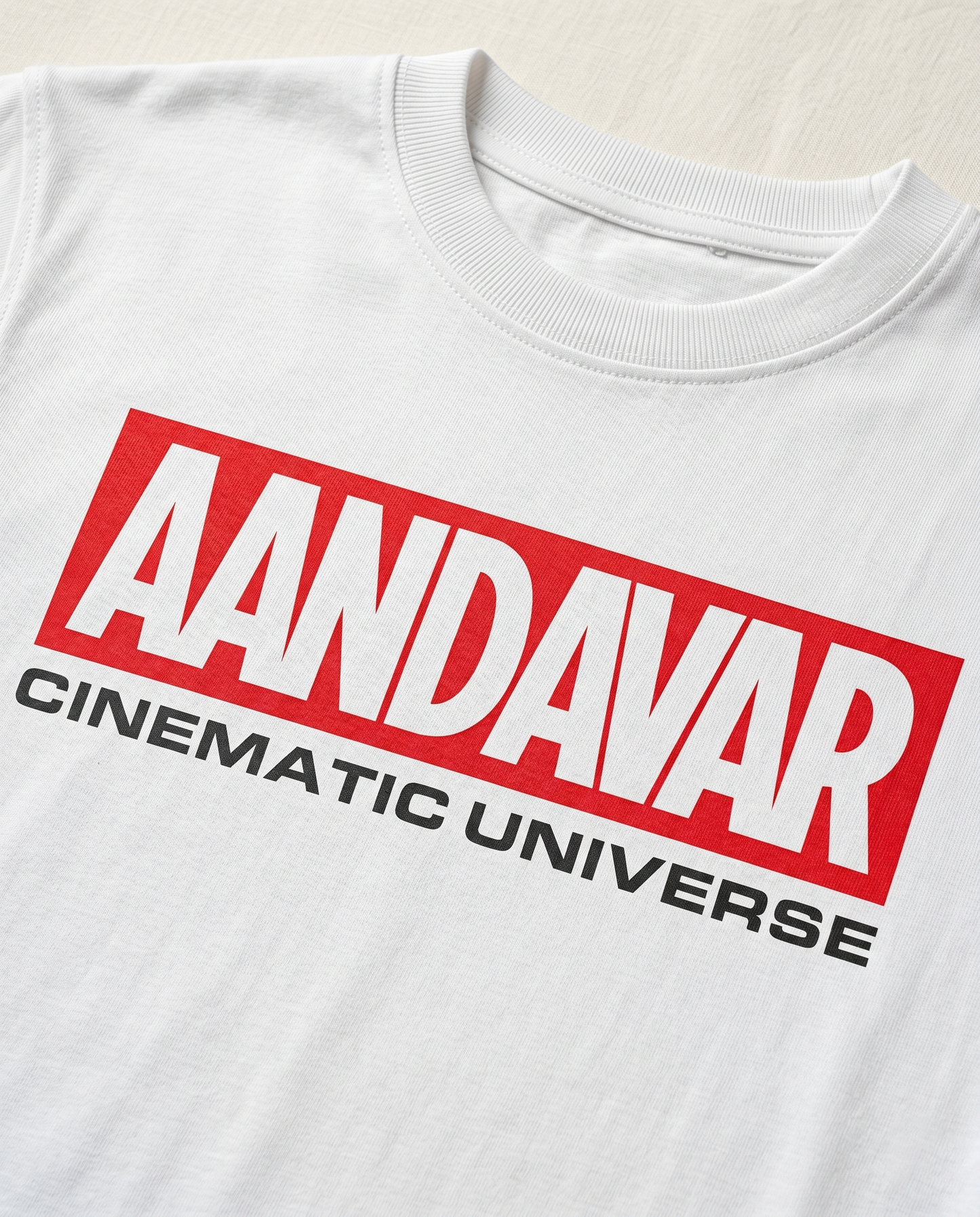 Detailed close-up of the AANDAVAR CINEMATIC UNIVERSE front graphic print on a men's regular-fit t-shirt in white.