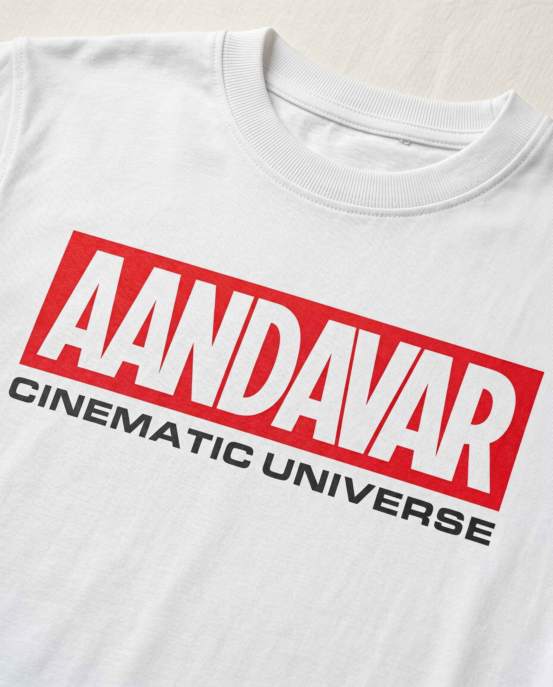 Detailed close-up of the AANDAVAR CINEMATIC UNIVERSE front graphic print on a men's regular-fit t-shirt in white.