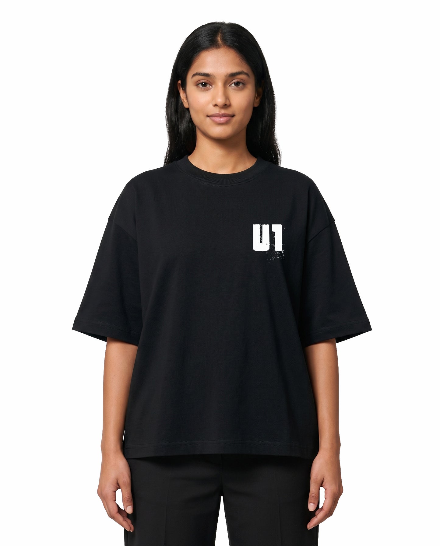 Front view of female model wearing ADDICTED TO U1 unisex oversized graphic t-shirt in black in a studio setting.
