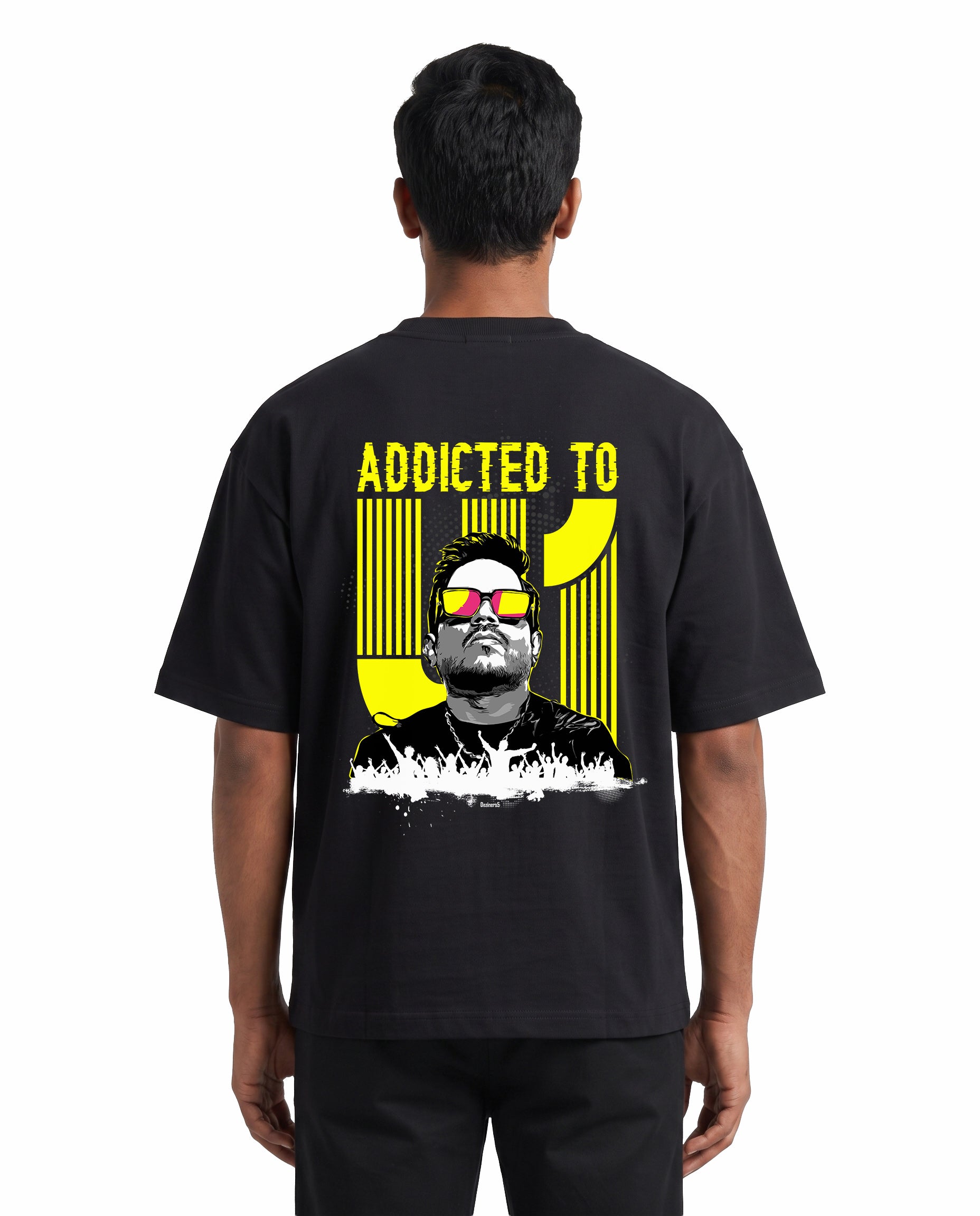 Back view of male model wearing ADDICTED TO U1 unisex oversized graphic t-shirt in black in a studio setting.