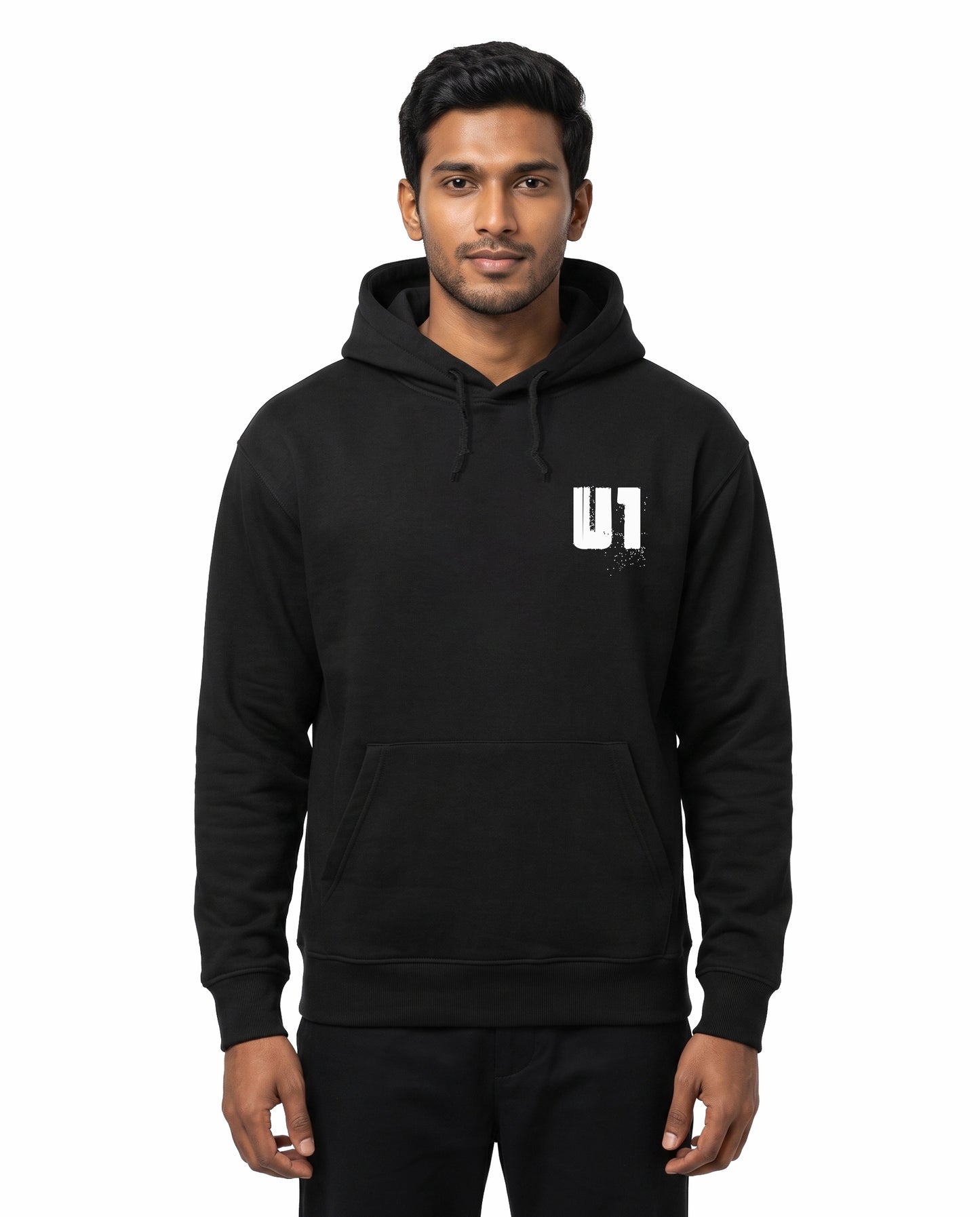 Front view of male model wearing ADDICTED TO U1 unisex regular-fit hoodie in black in a studio setting.