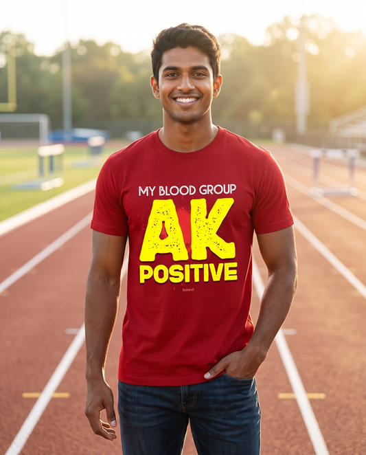 Young South Indian male wearing the AK POSITIVE men's regular-fit t-shirt in red on a sunrise running track with an uplifting atmosphere.