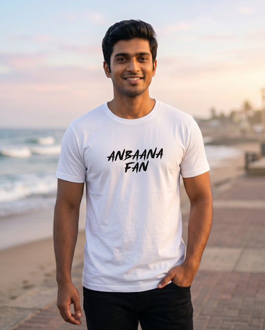 Young South Indian male wearing the ANBAANA FAN men's regular-fit t-shirt in white in a nostalgic romantic outdoor setting.