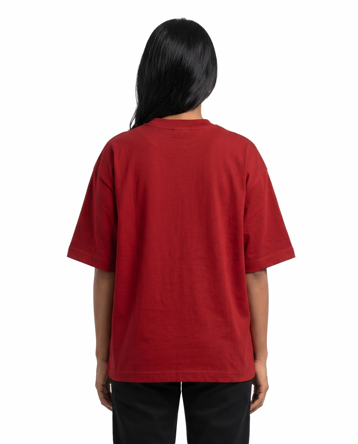 Back view of female model wearing ANI RULES - Unisex Oversized Graphic T-Shirt in red in a studio setting. 