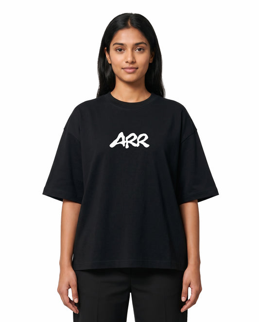 Front view of female model wearing ARR TRIBUTE - Unisex Oversized Graphic T-Shirt in black in a studio setting.