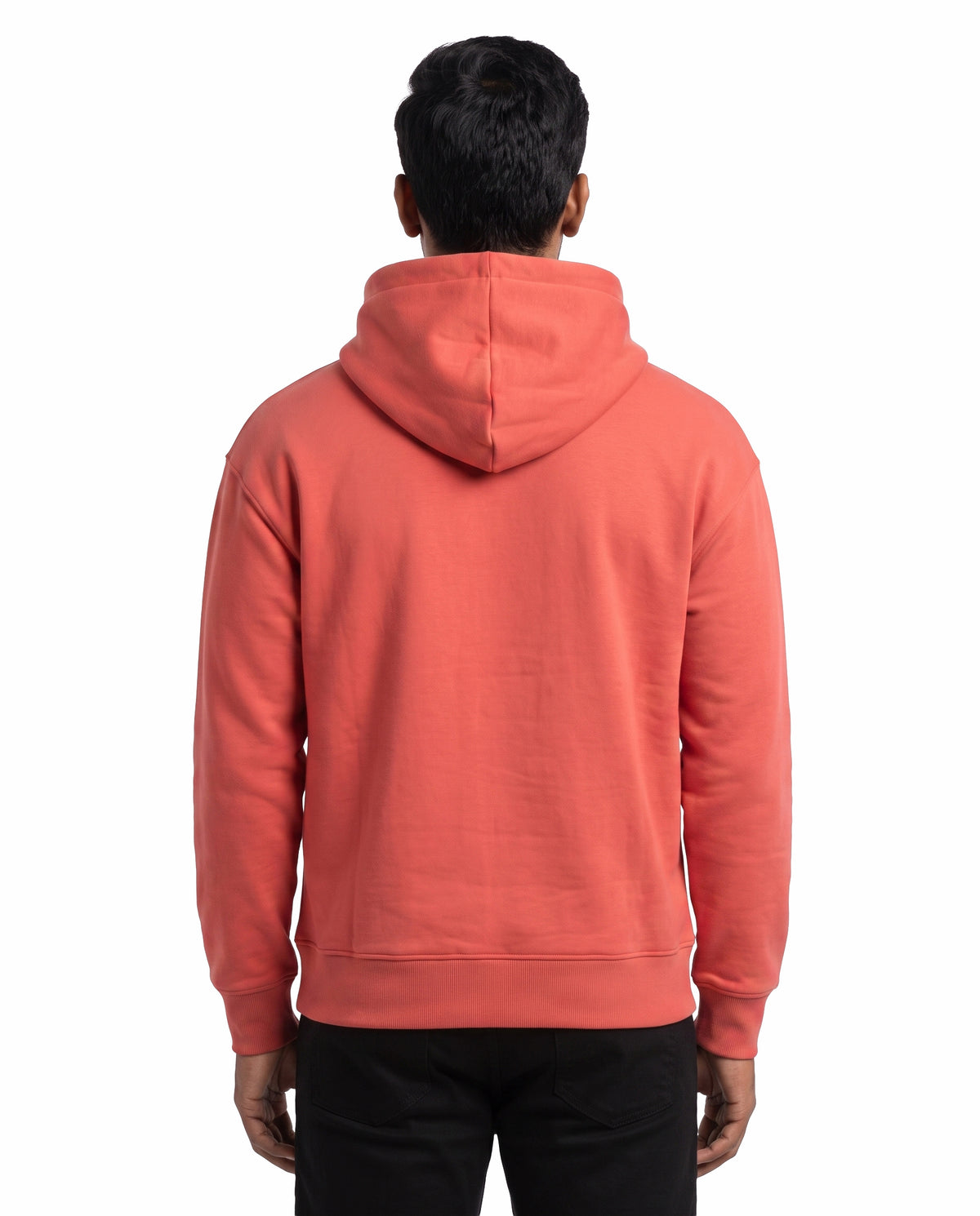 Back view of male model wearing ARR VIBES - Unisex Regular Fit Hoodie in coral in a studio setting.
