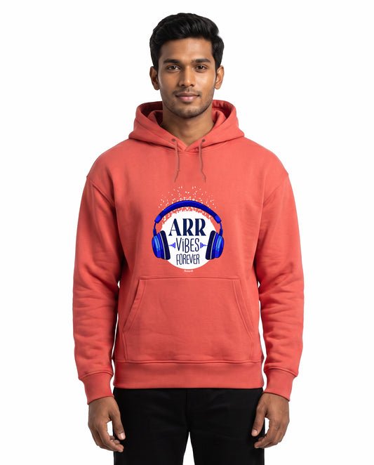Front view of male model wearing ARR VIBES - Unisex Regular Fit Hoodie in coral in a studio setting.