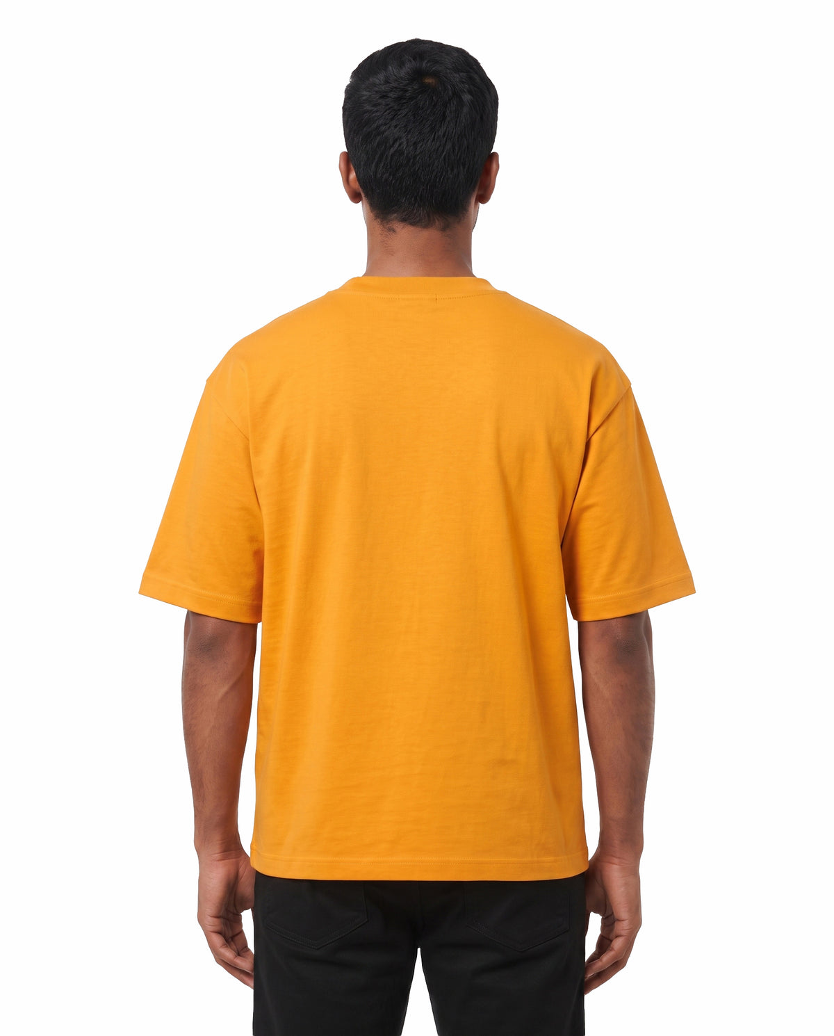 Back view of male model wearing ARR VIBES - Unisex Oversized Graphic T-Shirt in golden yellow in a studio setting.