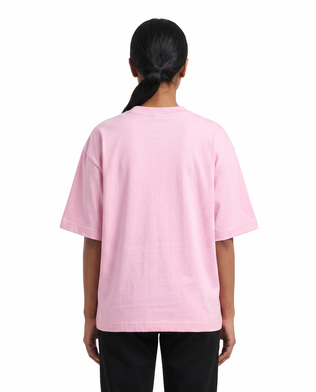 Back view of male model wearing ARR VIBES - Unisex Oversized Graphic T-Shirt in light baby pink in a studio setting.