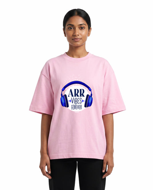 Front view of female model wearing ARR VIBES - Unisex Oversized Graphic T-Shirt in light baby pink in a studio setting.
