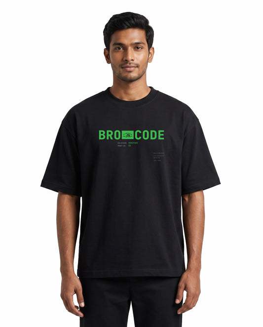 Front view of male model wearing BRO CODE unisex oversized graphic t-shirt in black in a studio setting.