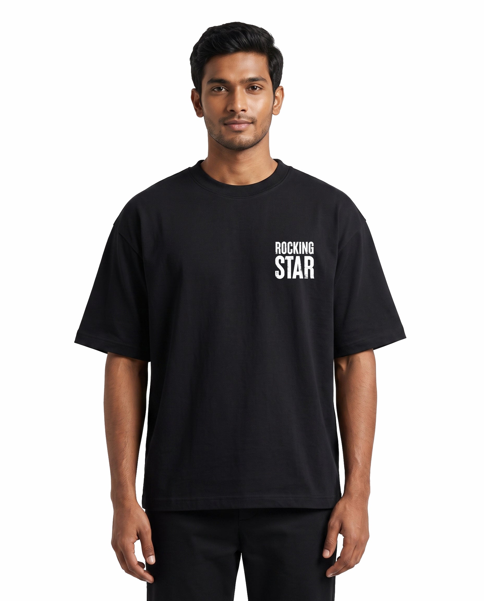 Front view of male model wearing DADDY'S HOME unisex oversized graphic t-shirt in black in a studio setting.