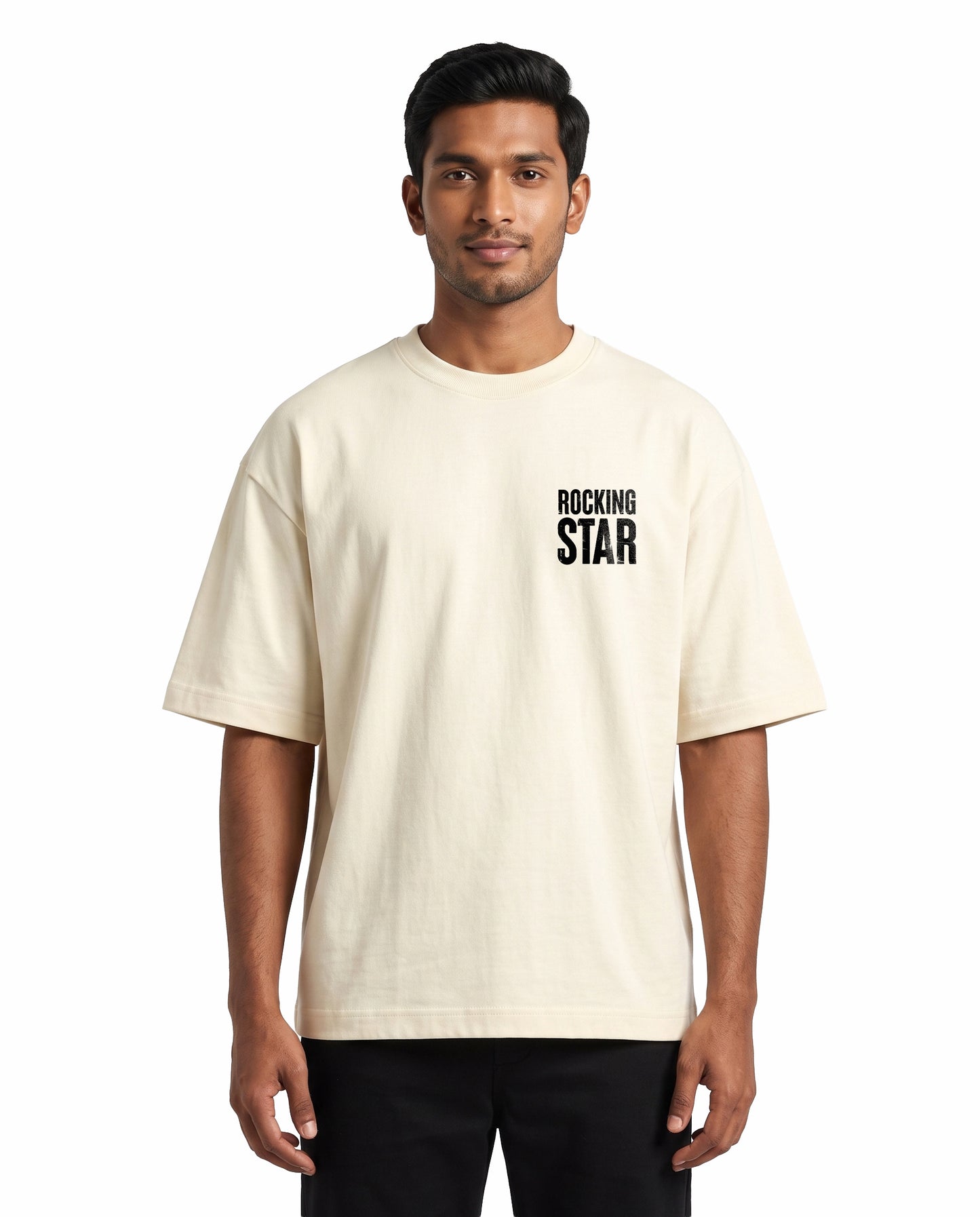 Front view of male model wearing DADDY'S HOME unisex oversized graphic t-shirt in off-white in a studio setting.