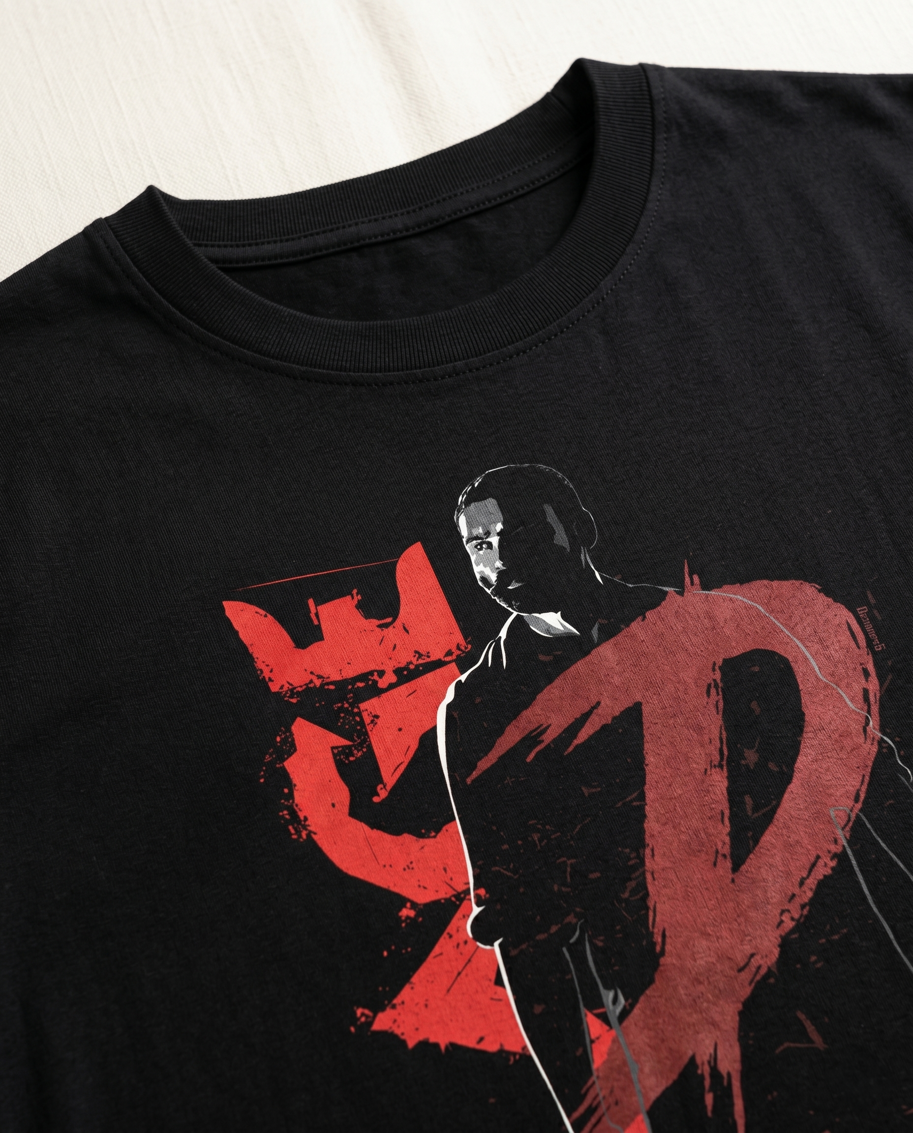 Close-up view of the D'S RAGE illustrated graphic print highlighting premium print quality and artwork details on a black men's regular-fit t-shirt .