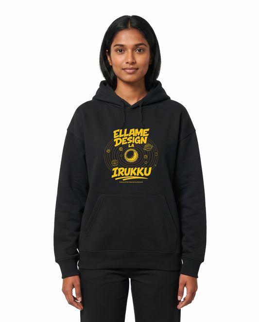 Front view of female model wearing ELLAME DESIGNLA IRUKKU - Unisex Regular Fit Hoodie in black in a studio setting.