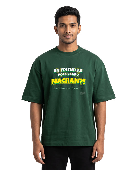 Front view of male model wearing EN FRIEND AH POLA YAARU MACHAN unisex oversized graphic t-shirt in bottle green in a studio setting.