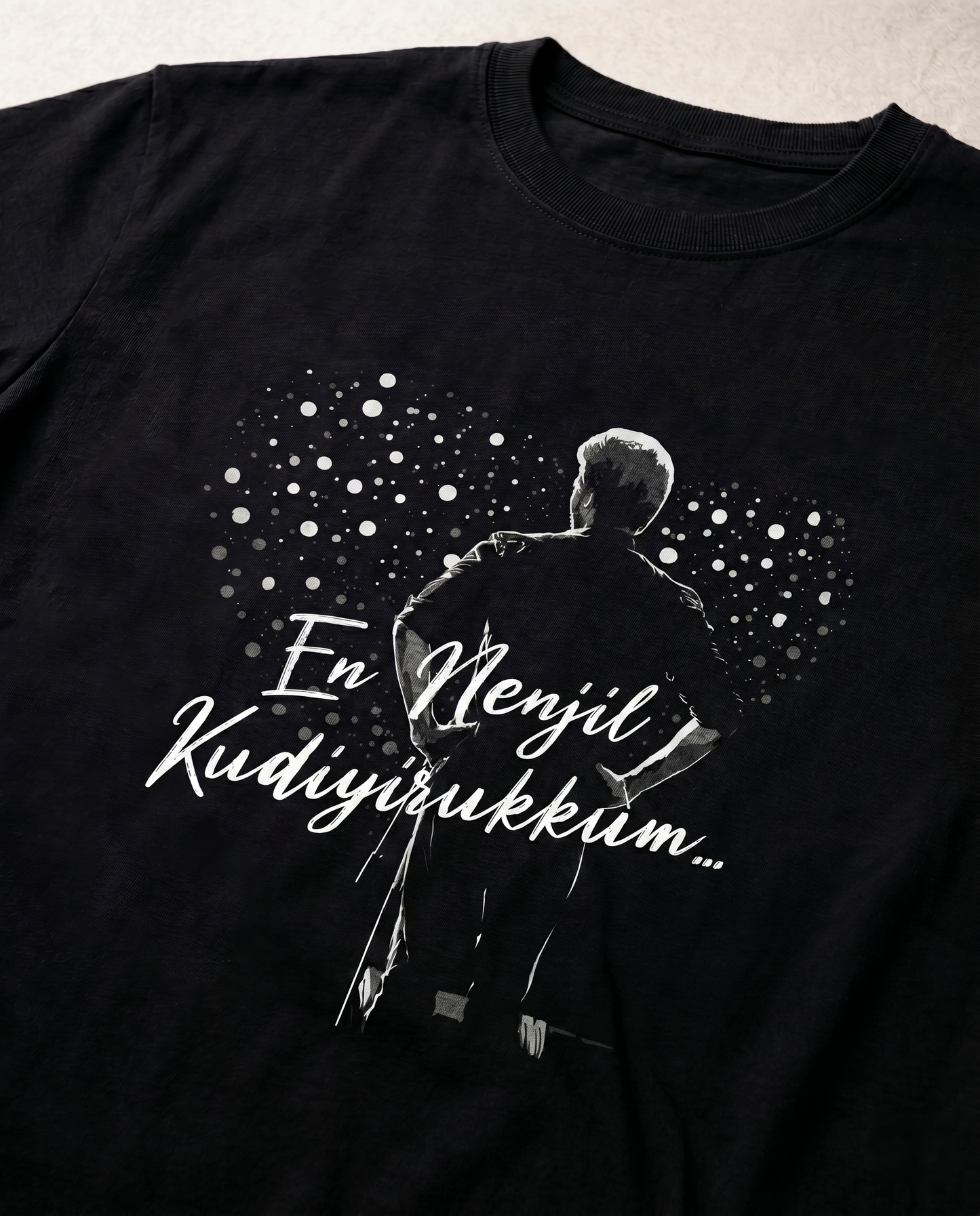 Close-up view of the EN NENJIL KUDIYIRUKKUM graphic print on a black men's regular-fit t-shirt showing premium print quality.