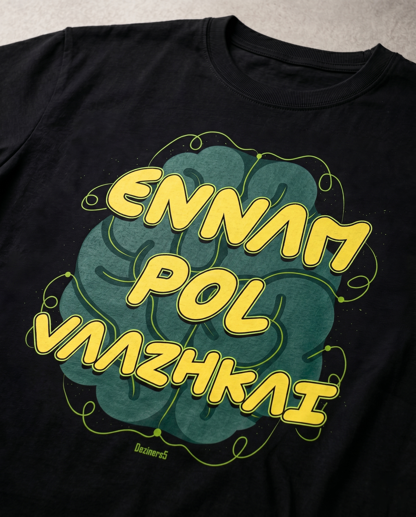Close-up view of the ENNAM POL VAAZHKAI typography graphic print highlighting premium print quality and design details on a black men's regular-fit t-shirt.