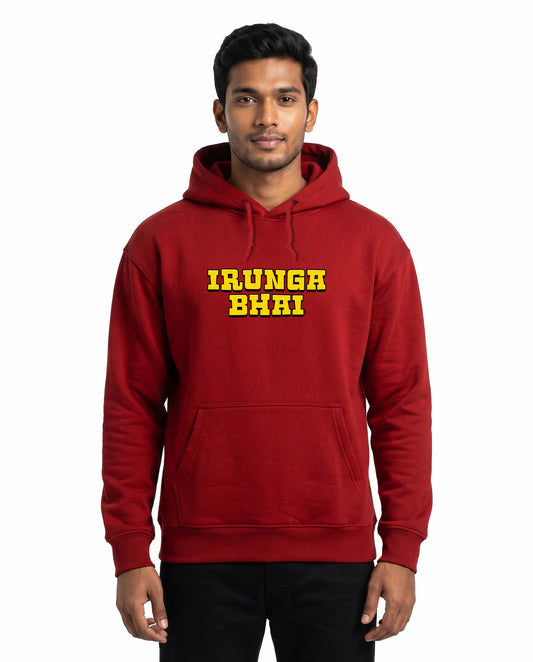 Front view of male model wearing IRUNGA BHAI - Unisex Regular Fit Hoodie in red in a studio setting.