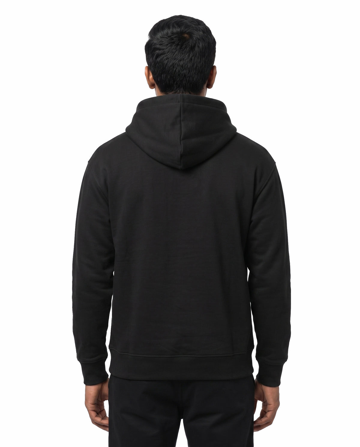 Back view of male model wearing ISAIPUYAL - Unisex Regular Fit Hoodie in black in a studio setting.
