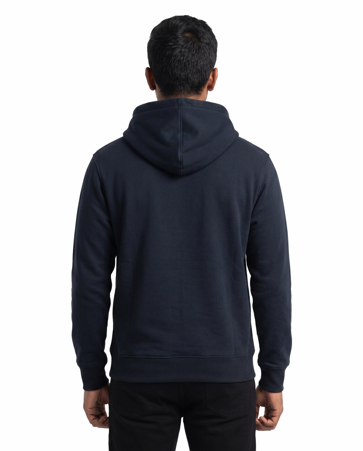Back view of male model wearing ISAIPUYAL - Unisex Regular Fit Hoodie in navy blue in a studio setting.