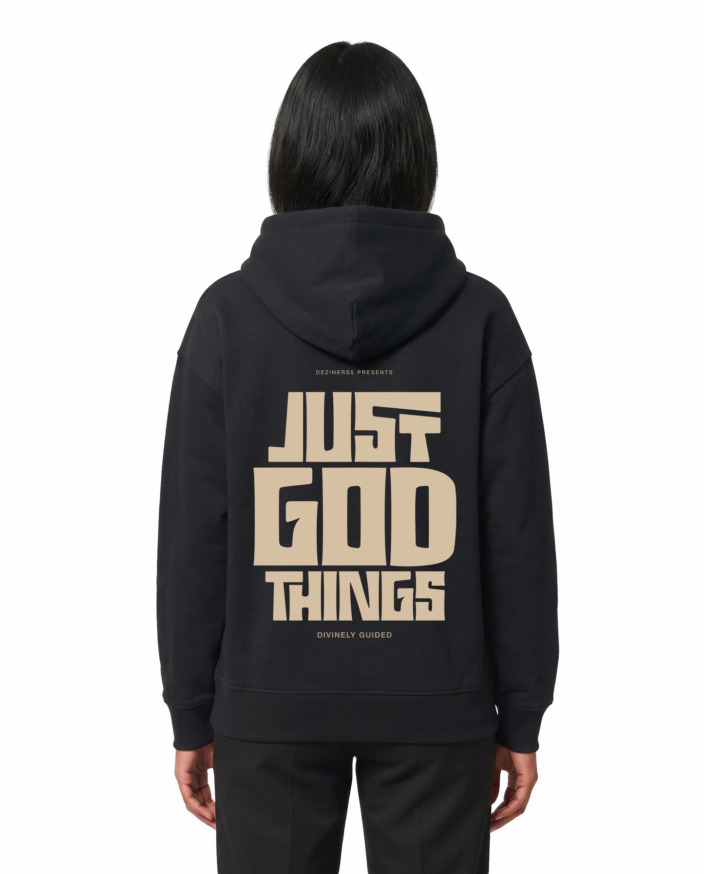 Back view of female model wearing JUST GOD THINGS - Unisex Regular Fit Hoodie in black in a studio setting.