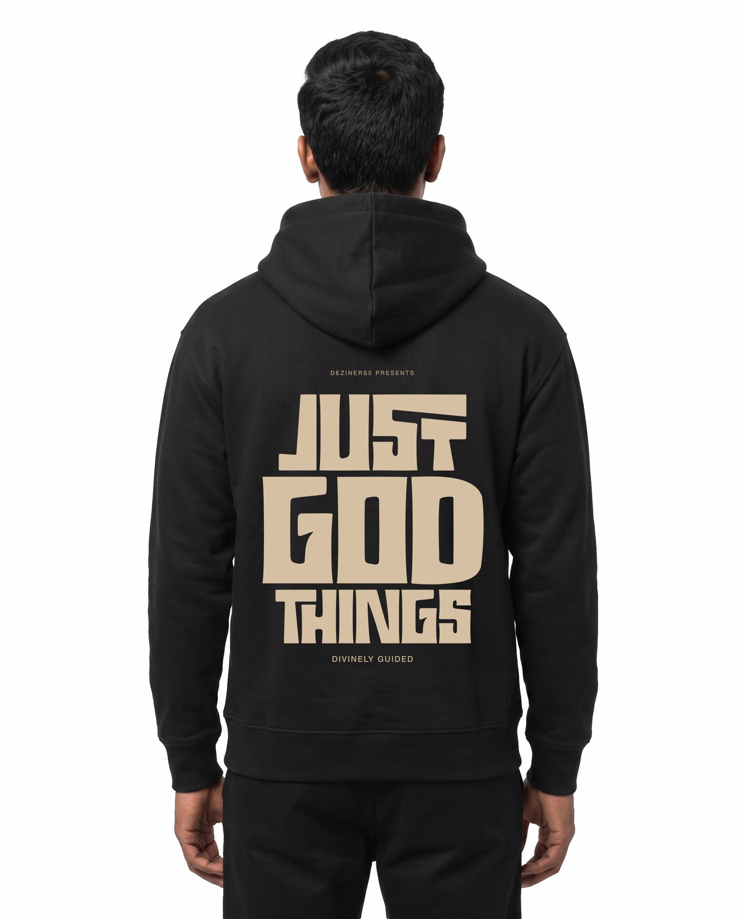 Back view of male model wearing JUST GOD THINGS - Unisex Regular Fit Hoodie in black in a studio setting.