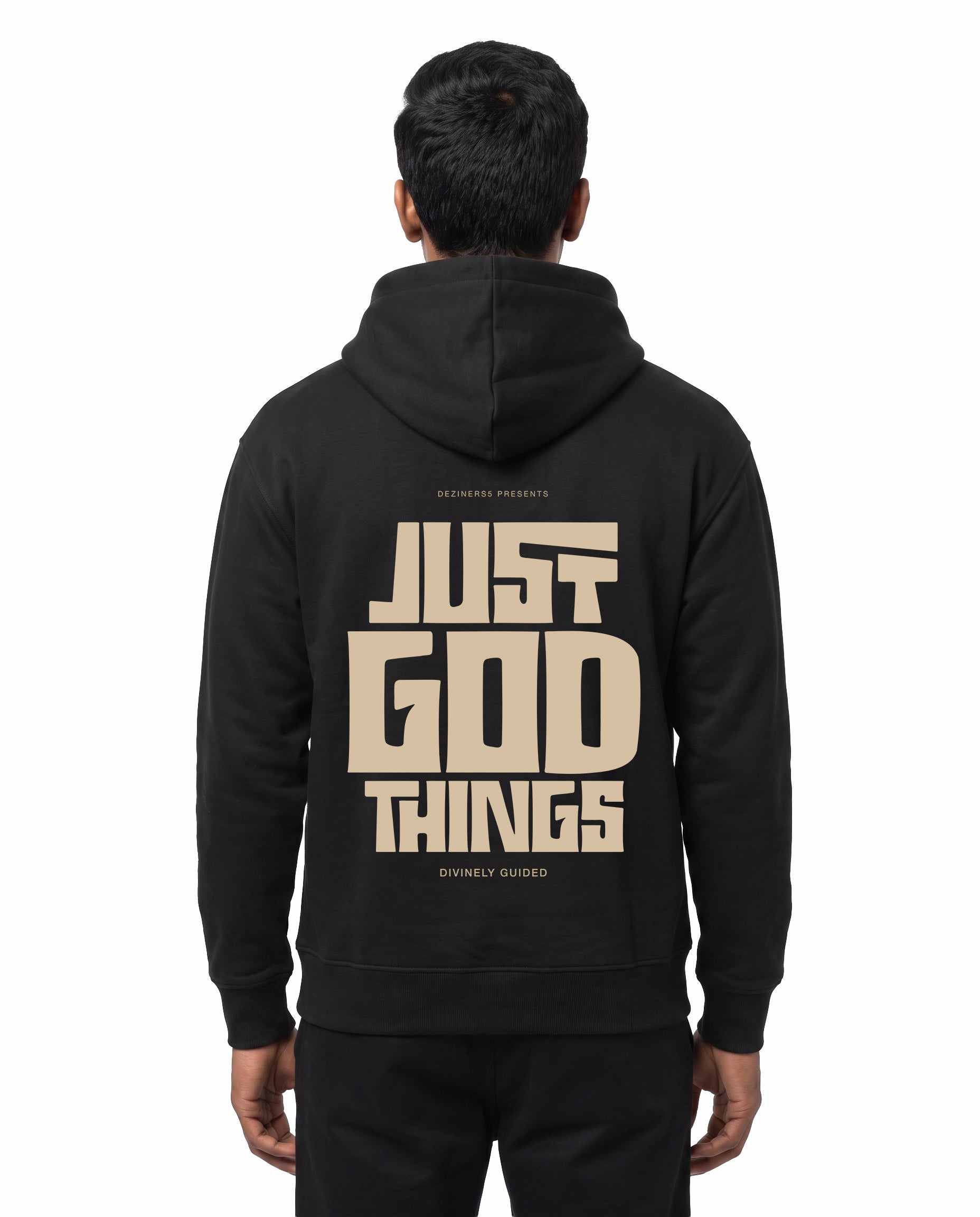 Back view of male model wearing JUST GOD THINGS - Unisex Regular Fit Hoodie in black in a studio setting.