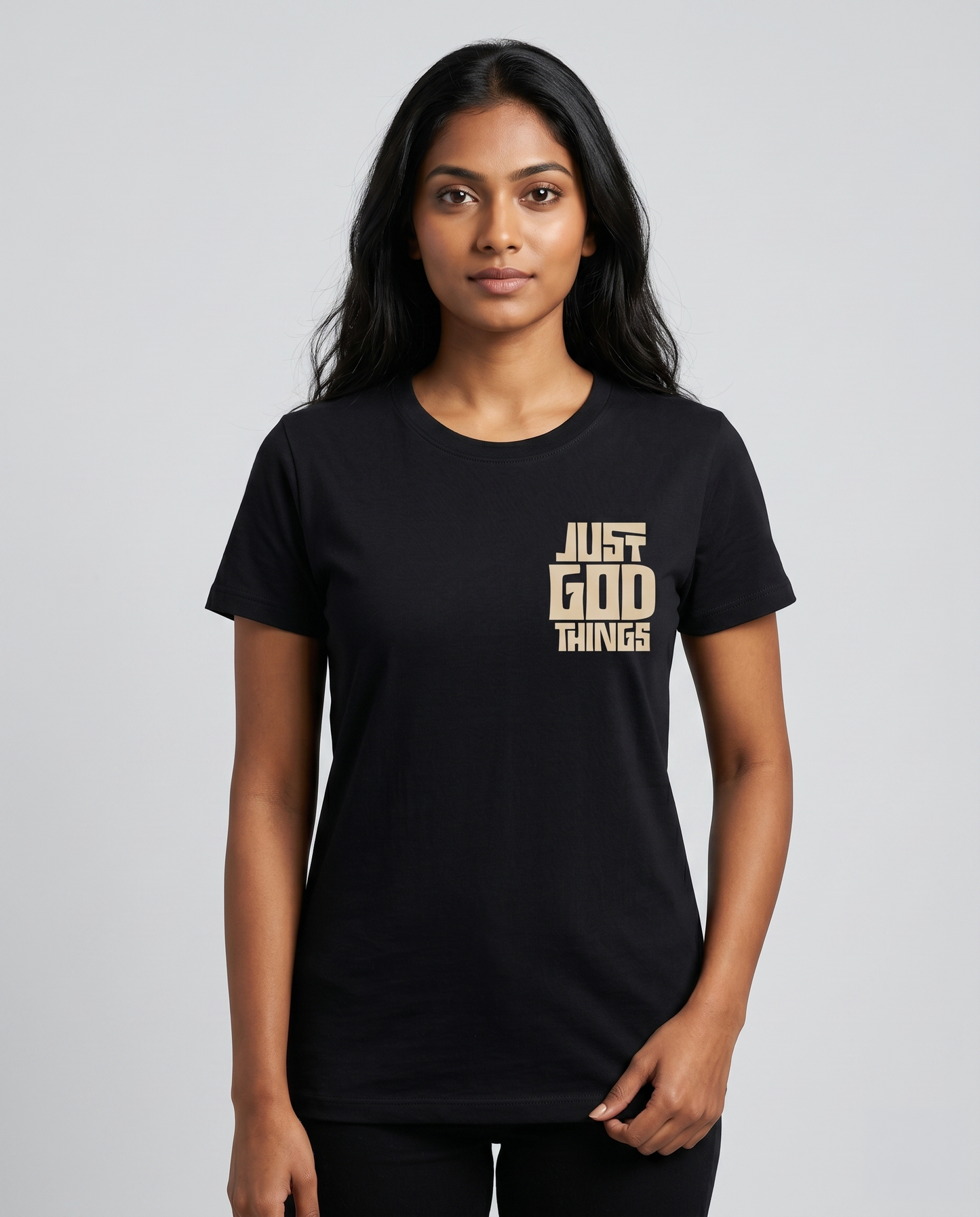 Young South Indian female model wearing JUST GOD THINGS women's regular fit black graphic t-shirt with chest print.