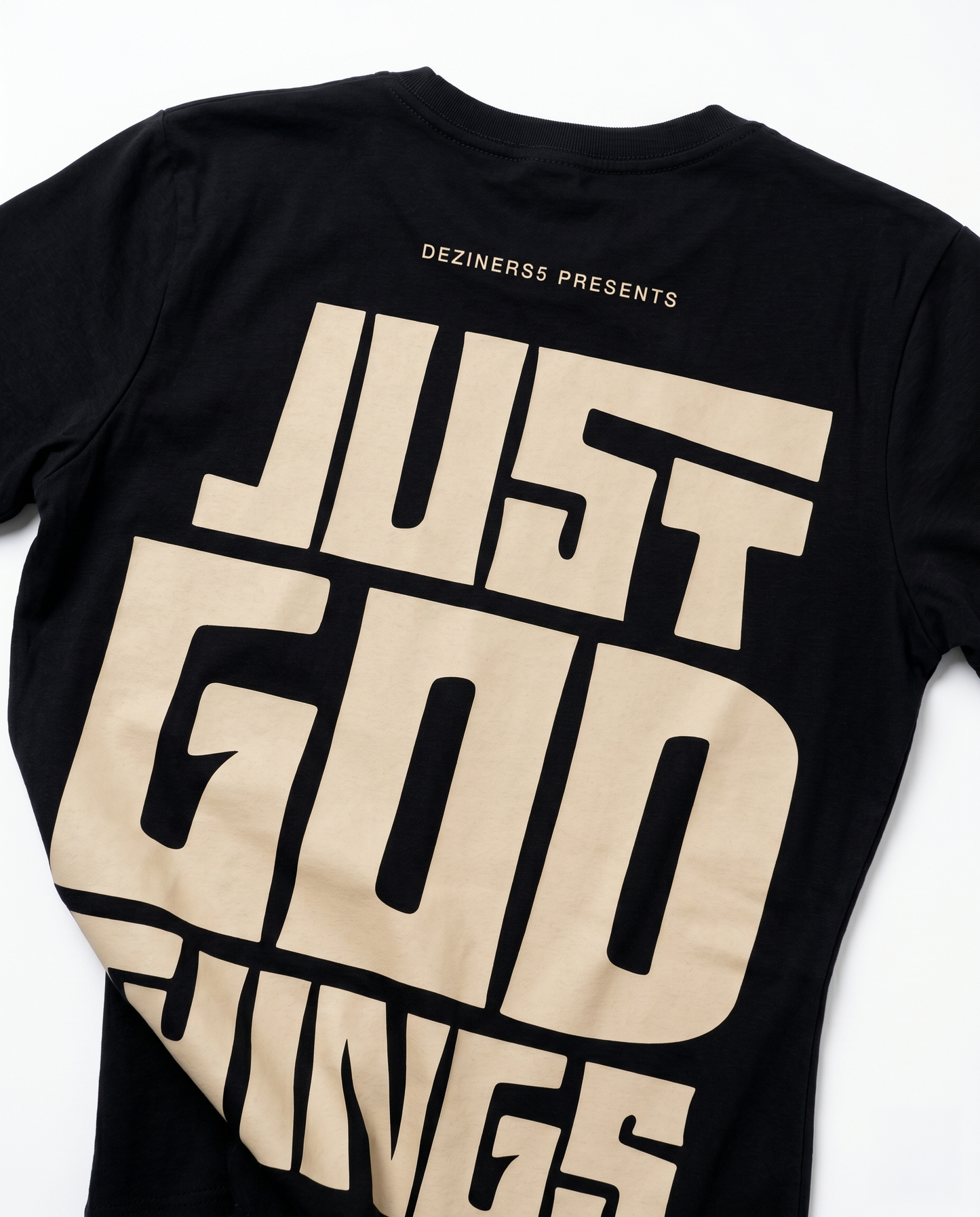 Close-up detail of JUST GOD THINGS graphic print on women's regular fit black cotton t-shirt.