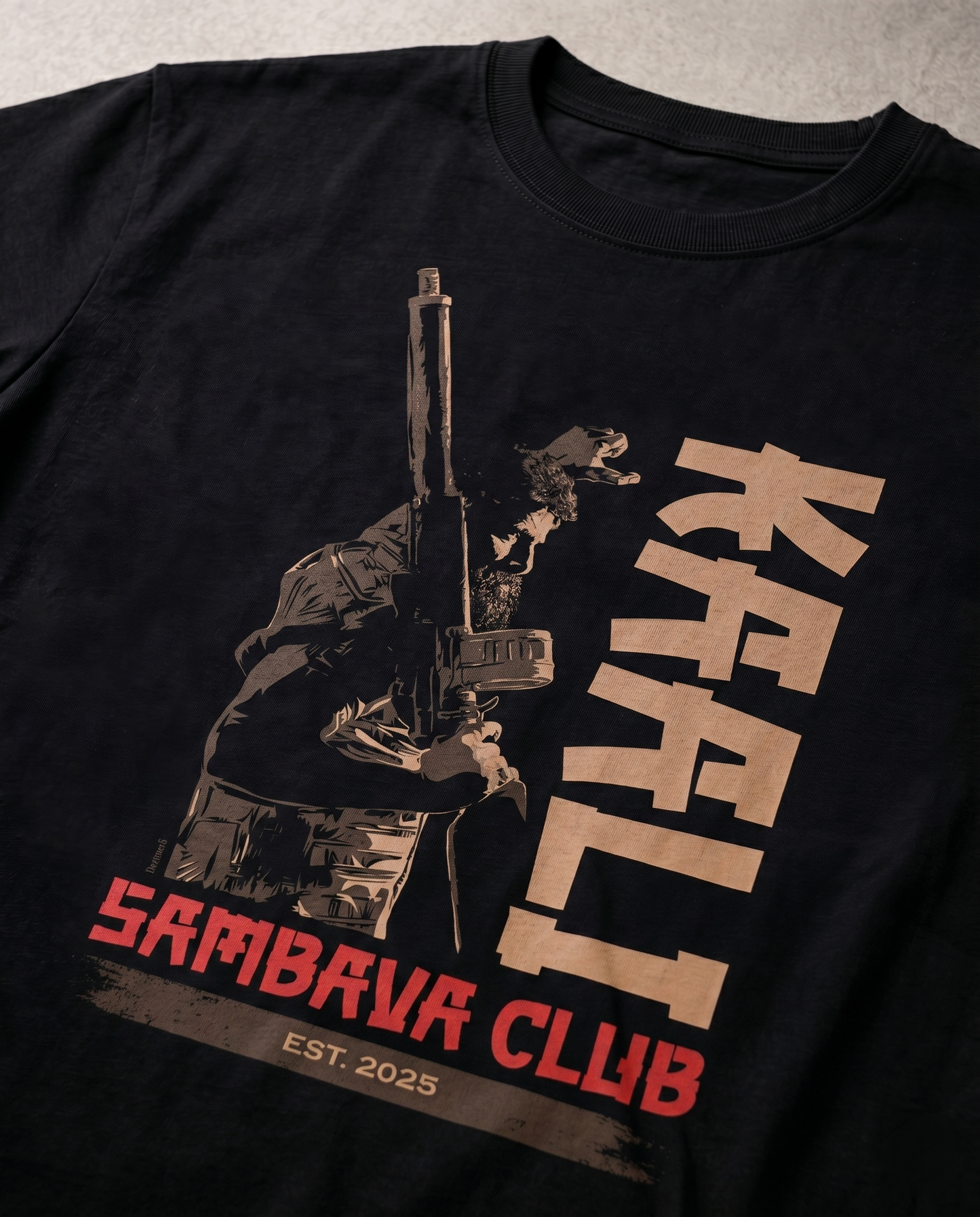 Detailed close-up of the KAALI SAMBAVA CLUB graphic print highlighting premium print quality and design elements on a black men's regular-fit t-shirt.