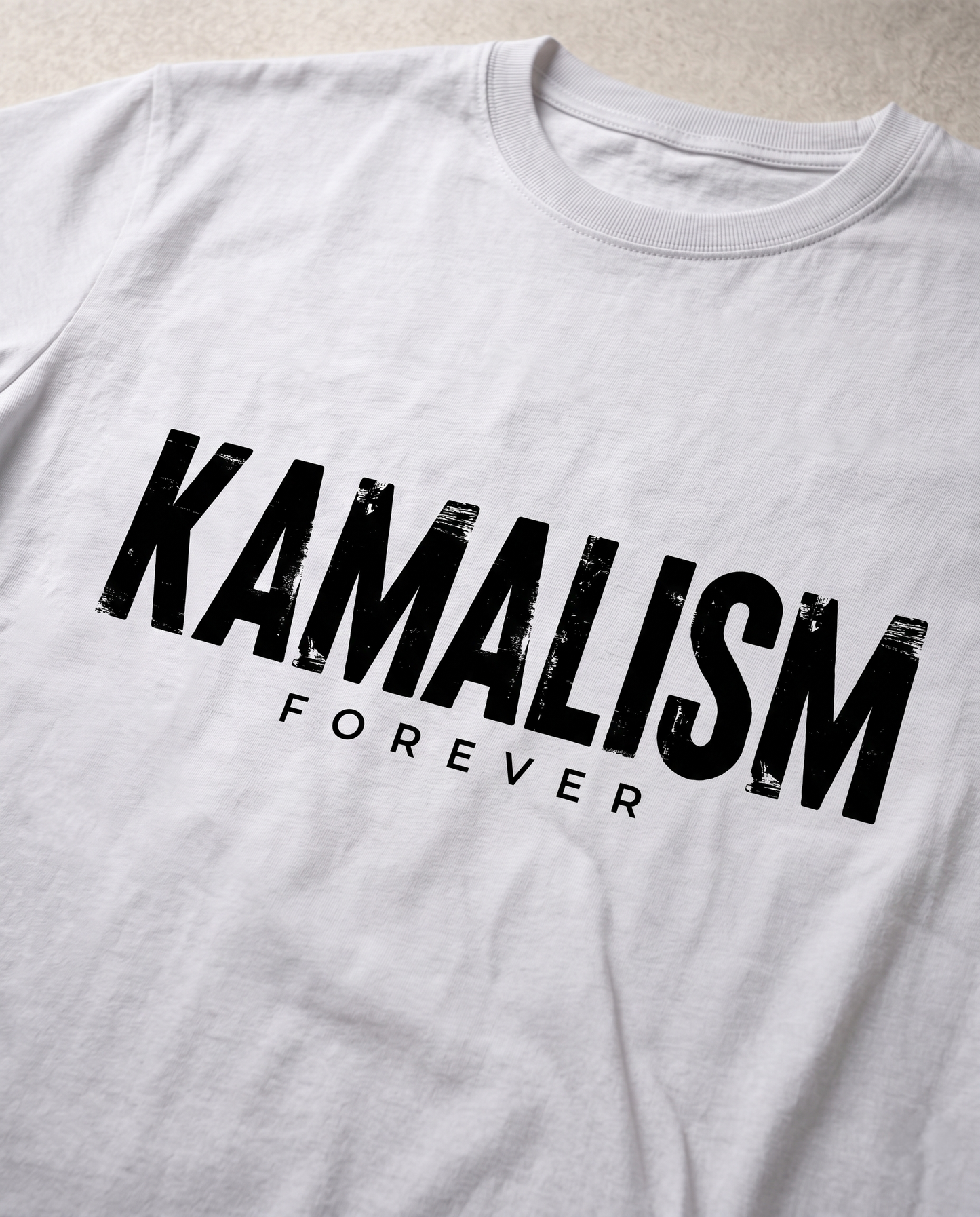 Close-up view of the KAMALISM FOREVER front graphic print showcasing premium print quality and design details on a white men's regular-fit t-shirt.