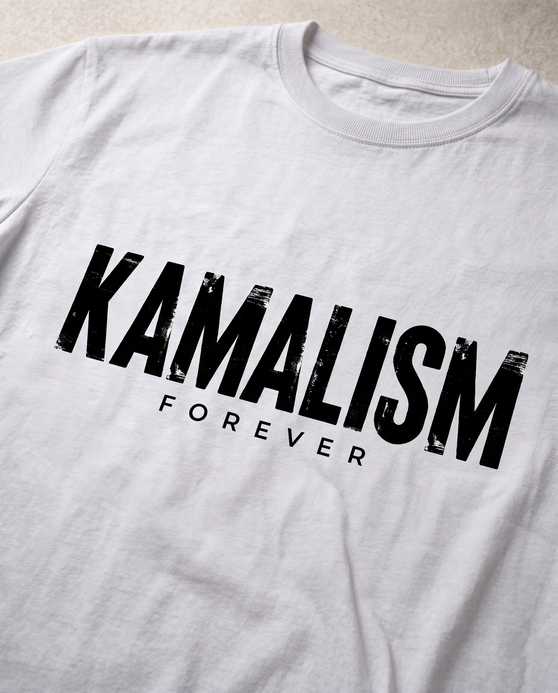 Close-up view of the KAMALISM FOREVER front graphic print showcasing premium print quality and design details on a white men's regular-fit t-shirt.