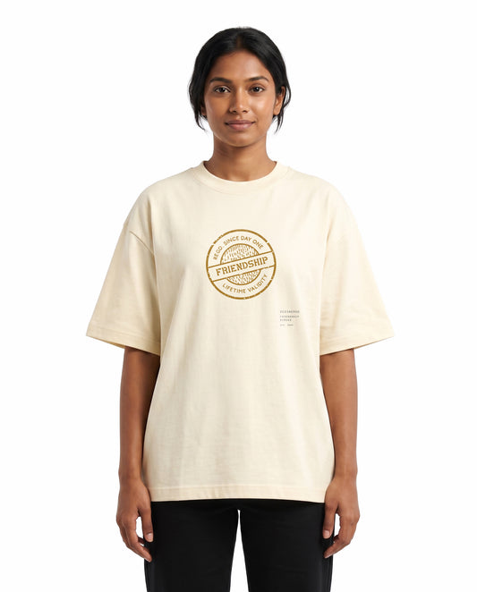 Front view of female model wearing LIFETIME VALIDITY unisex oversized graphic t-shirt in off-white in a studio setting.