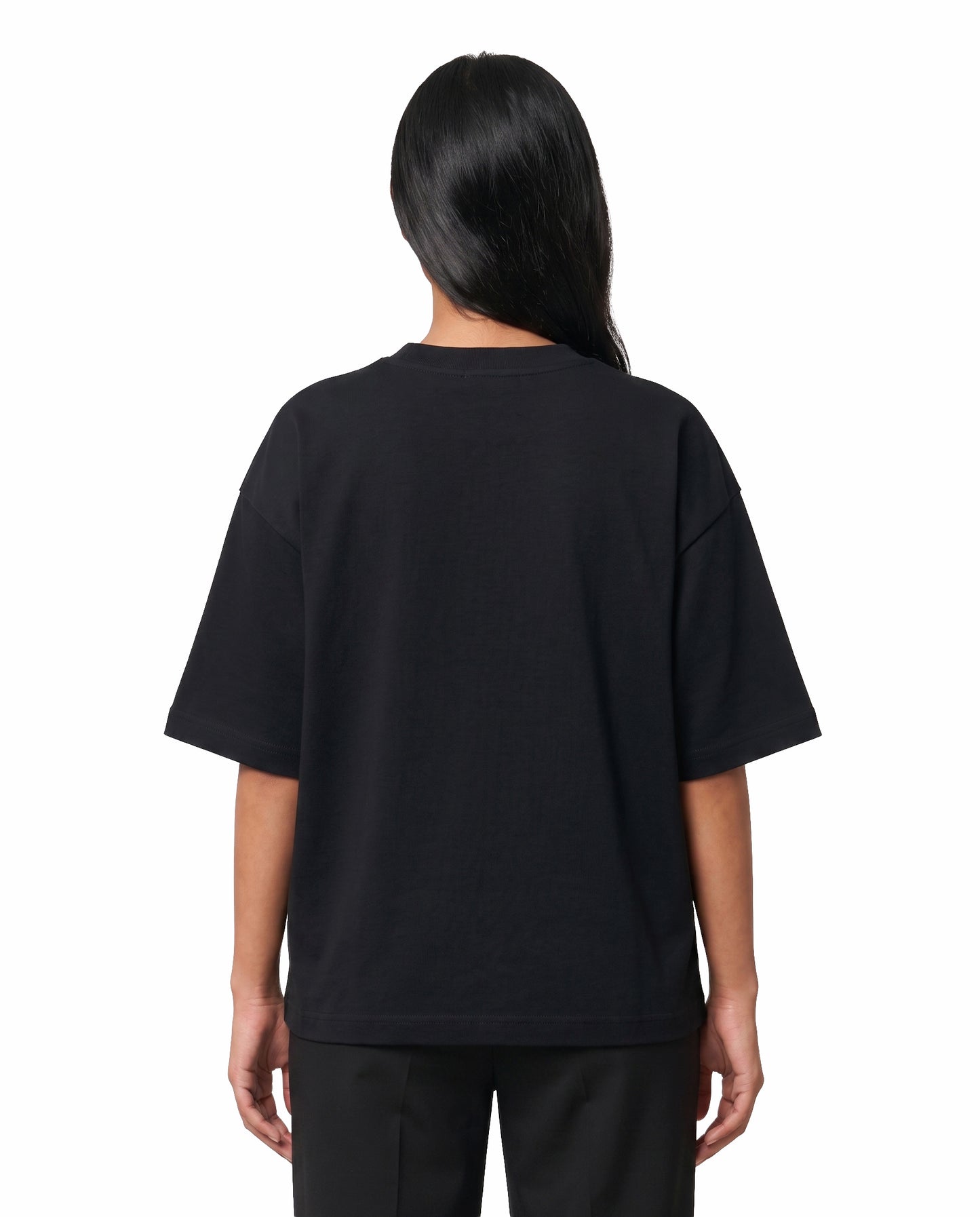 Back view of female model wearing NANBI oversized graphic t-shirt in black in a studio setting.