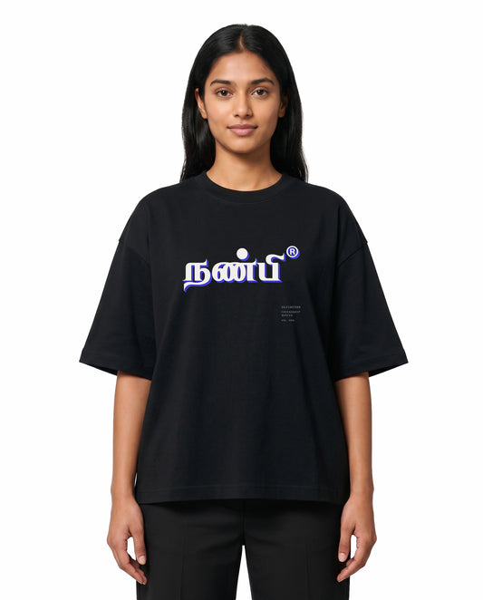 Front view of female model wearing NANBI oversized graphic t-shirt in black in a studio setting.
