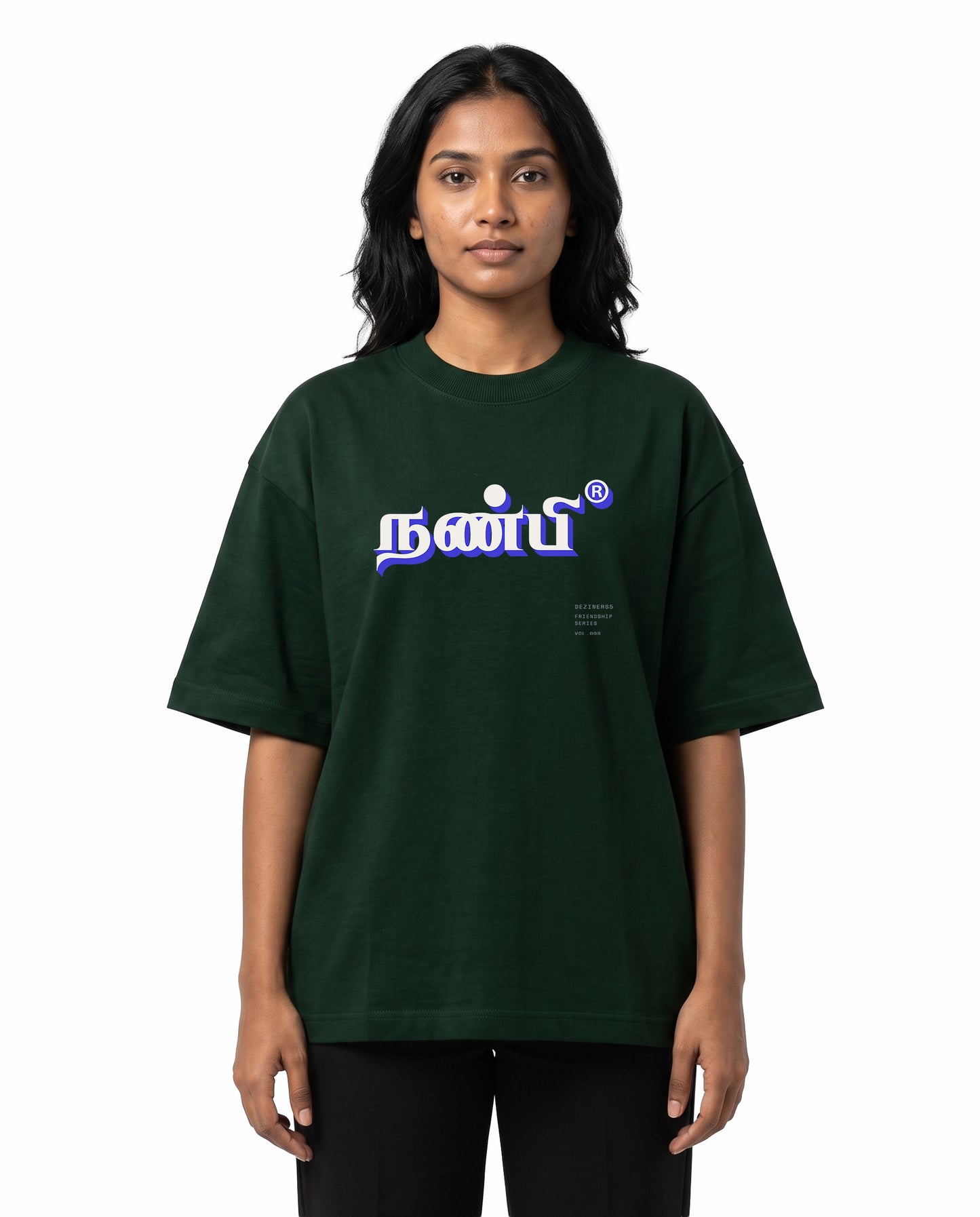 Front view of female model wearing NANBI oversized graphic t-shirt in bottle green in a studio setting.