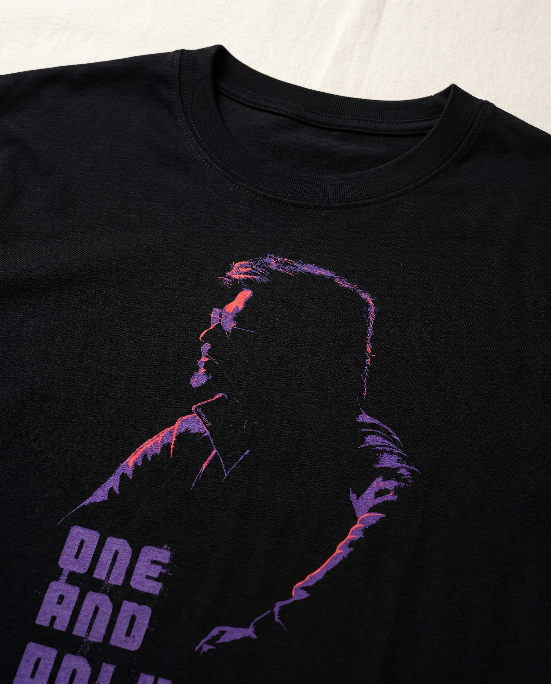 Close-up detail of NE AND ONLY Superstar inspired artwork printed on  a black men's regular-fit t-shirt.