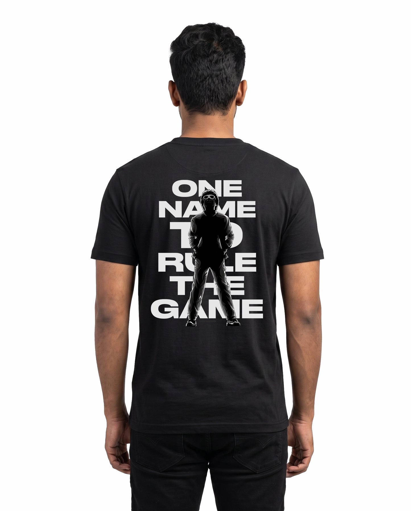 Back view of male model wearing ONE NAME men's regular-fit t-shirt in black in a studio setting.