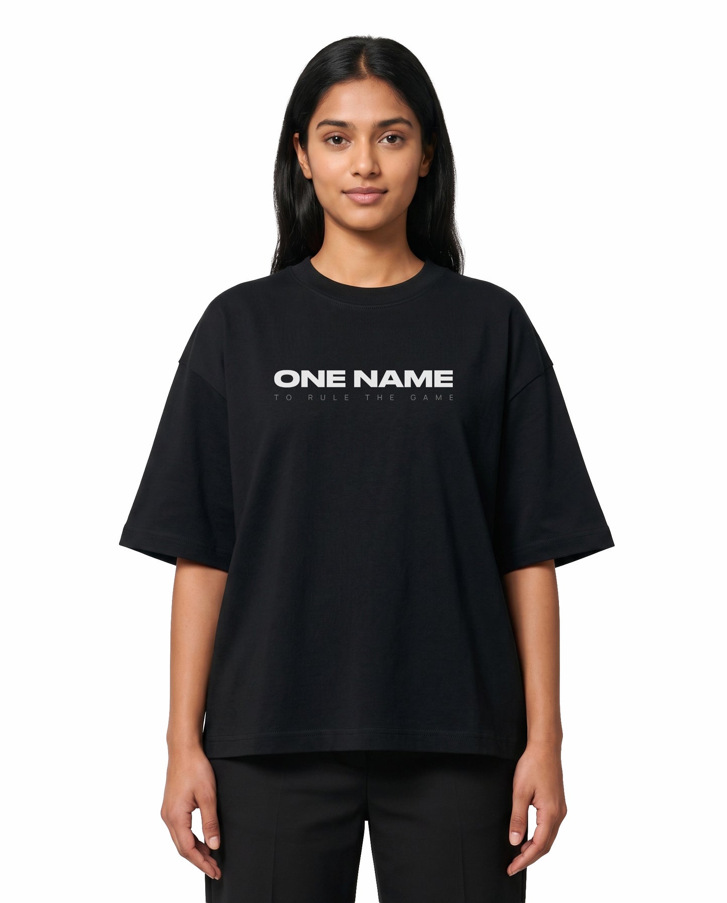 Front view of female model wearing ONE NAME unisex oversized graphic t-shirt in black in a studio setting.