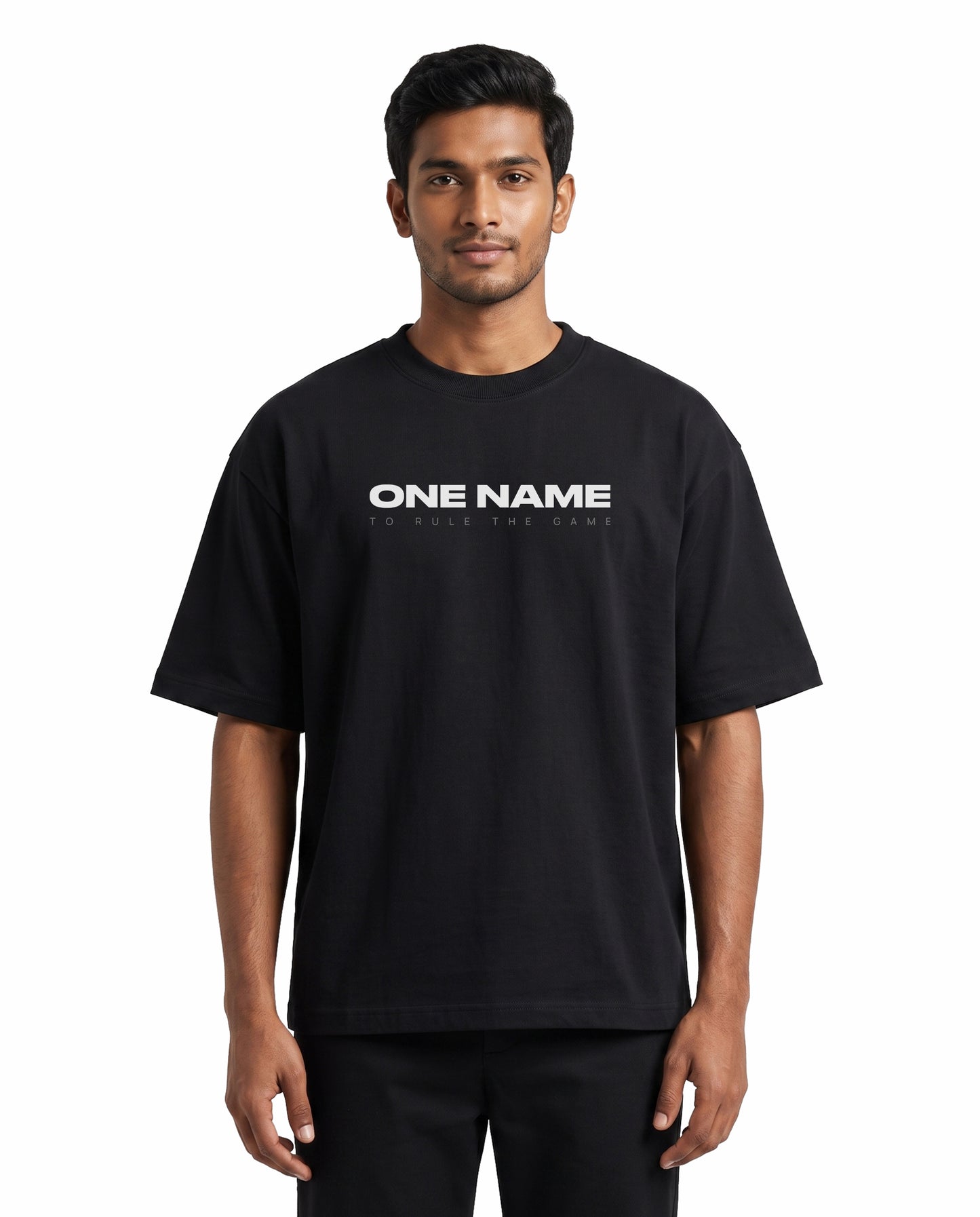 Front view of male model wearing ONE NAME unisex oversized graphic t-shirt in black in a studio setting.