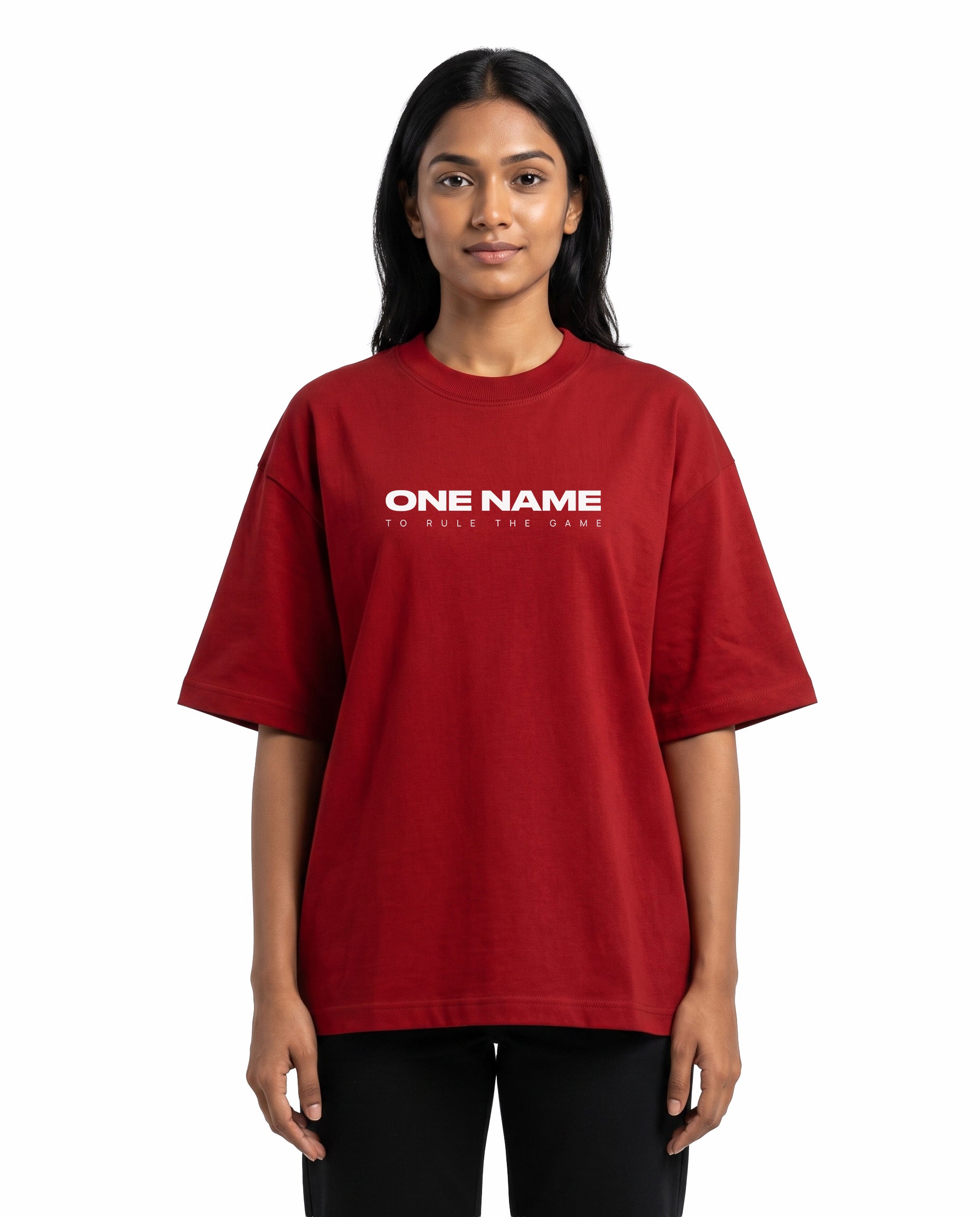 Front view of female model wearing ONE NAME unisex oversized graphic t-shirt in red in a studio setting.