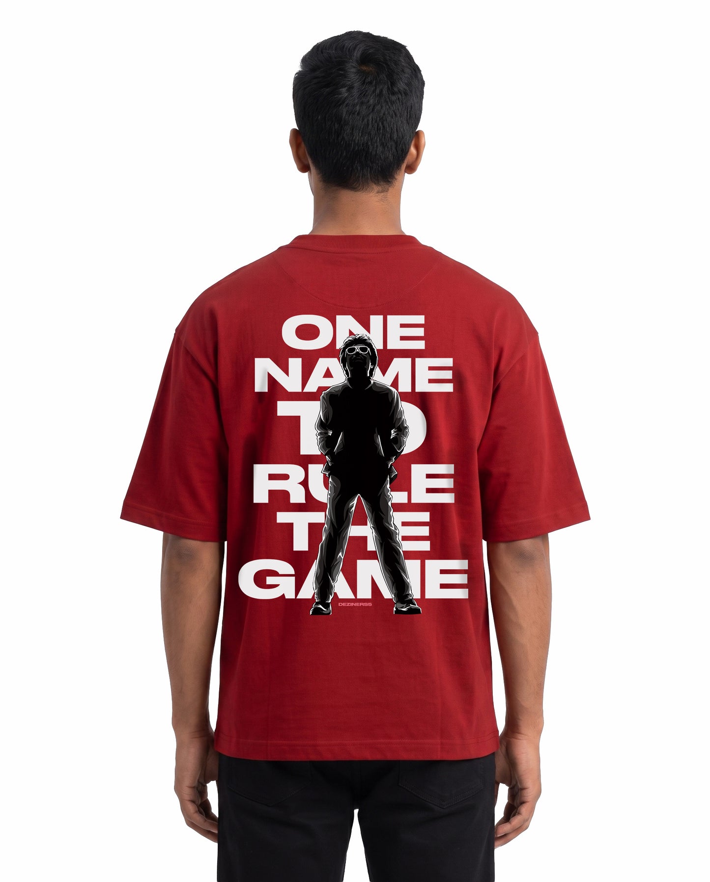 Back view of male model wearing ONE NAME unisex oversized graphic t-shirt in red in a studio setting.