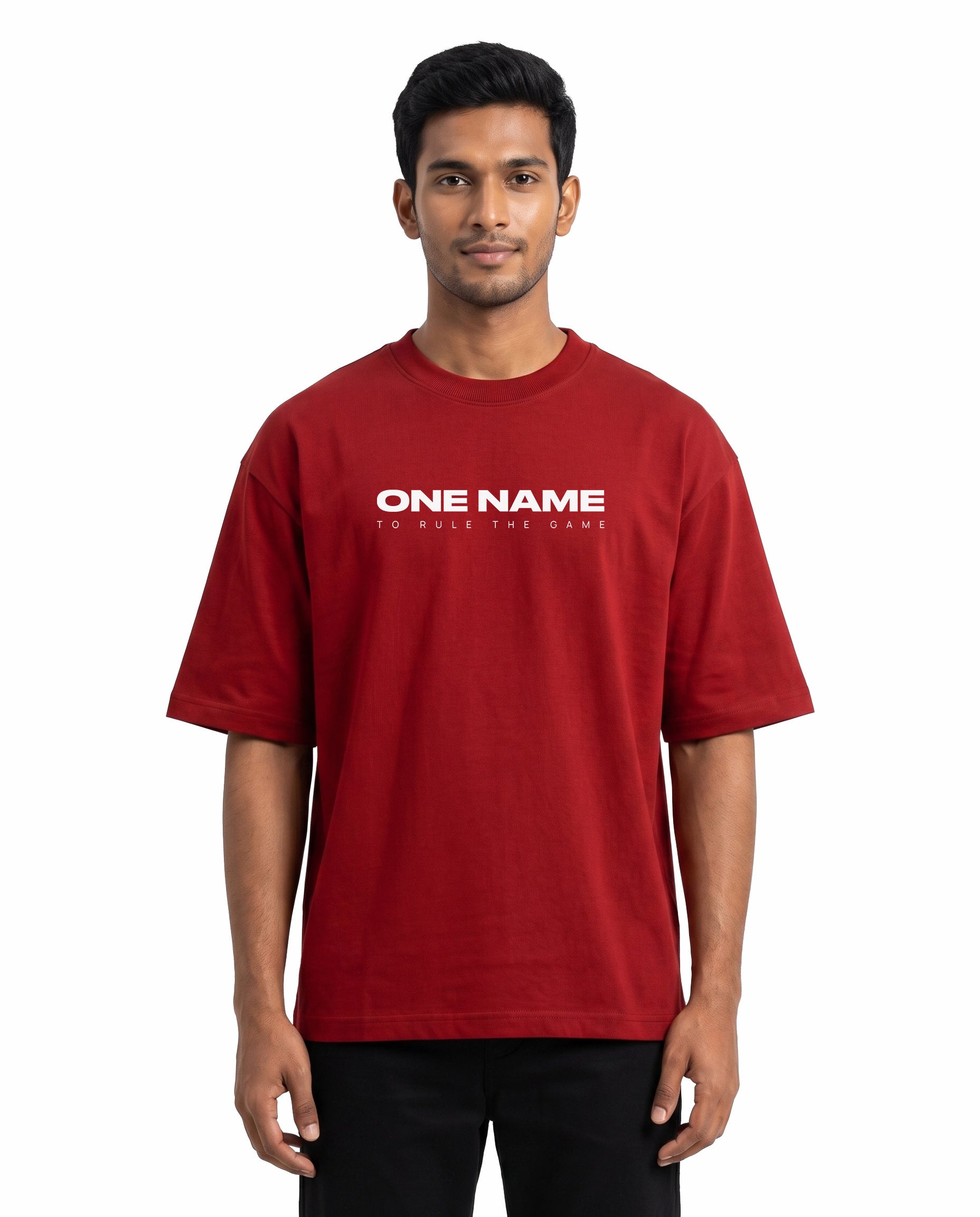 Front view of male model wearing ONE NAME unisex oversized graphic t-shirt in red in a studio setting.