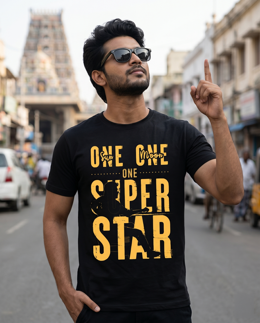 Young South Indian man wearing ONE SUPERSTAR black regular fit t-shirt with bold front print in a Chennai urban lifestyle setting.